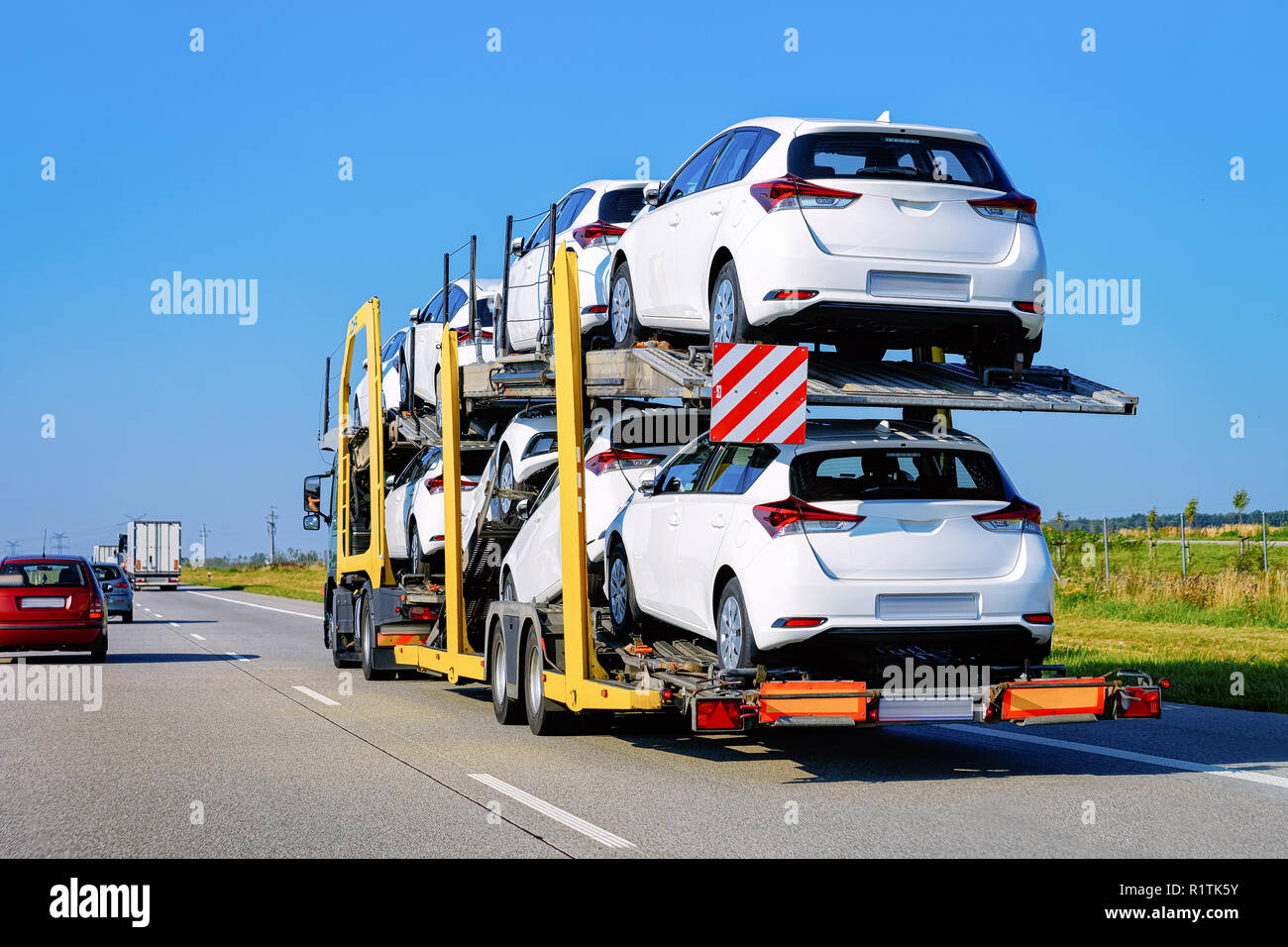 Cars carrier truck at the asphalt road in Poland. Truck transporter ...