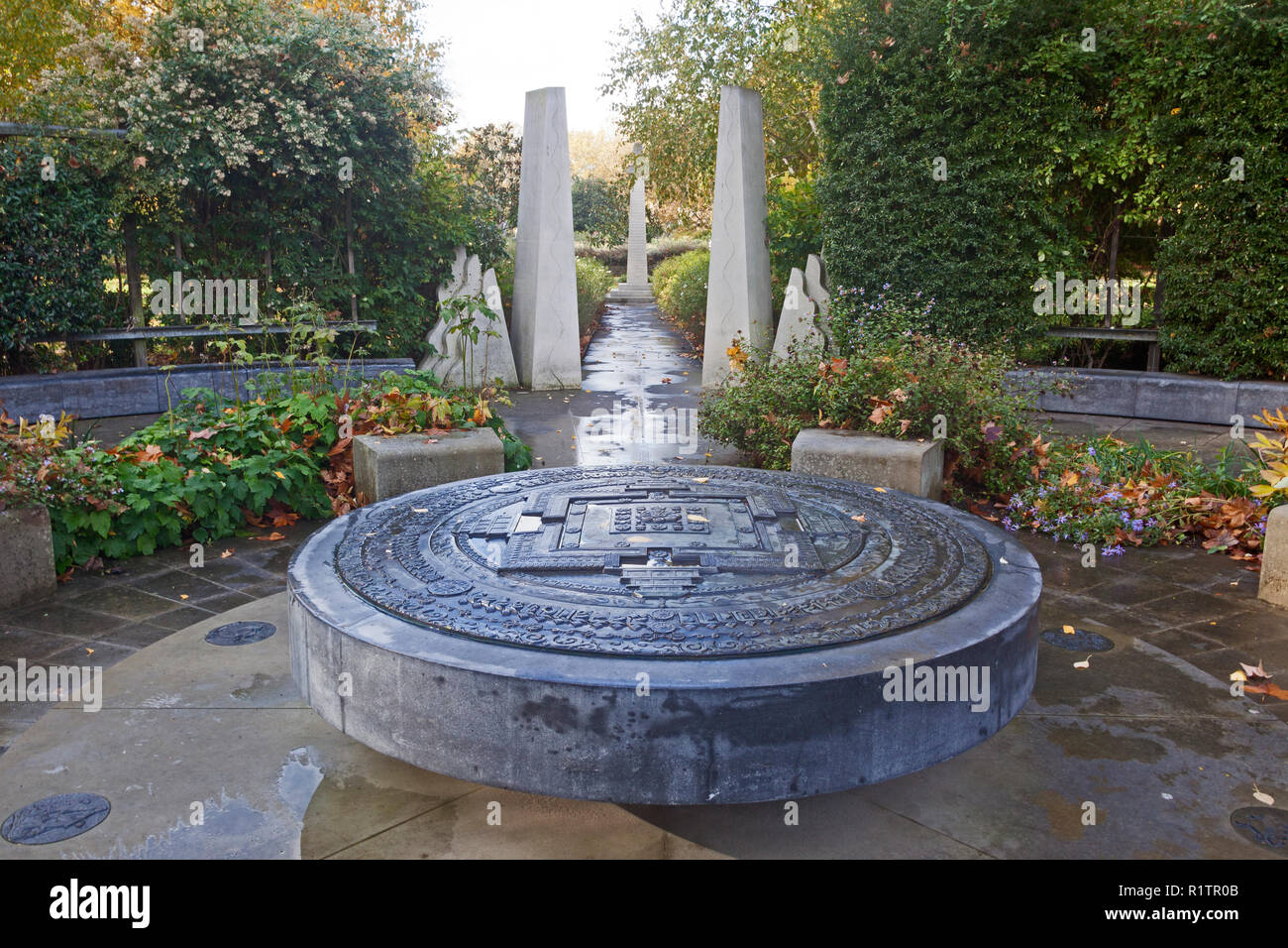 London, Lambeth. The Tibetan Peace Garden close to the Imperial War Museum. In the foreground is the black limestone Kalachakra Mandala. Stock Photo