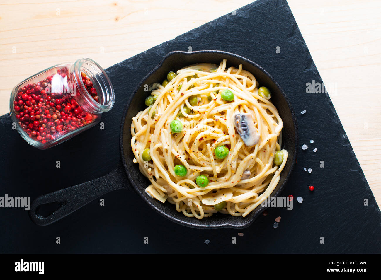 Food concept homemade spaghetti creamy white sauce in castiron skillet