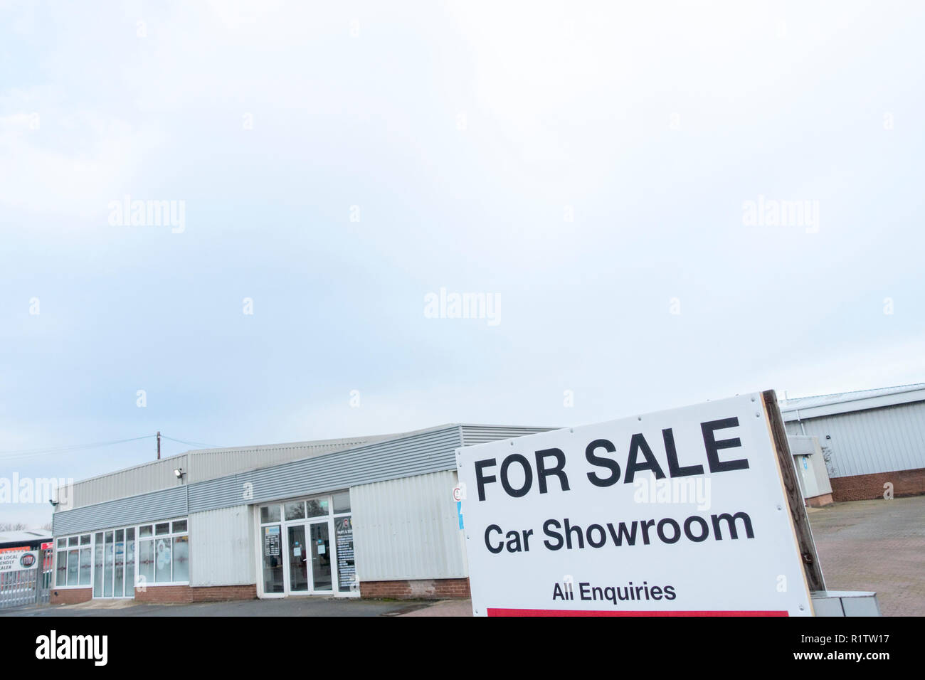 The white tiled showroom of a closed and abandoned FIAT car dealership