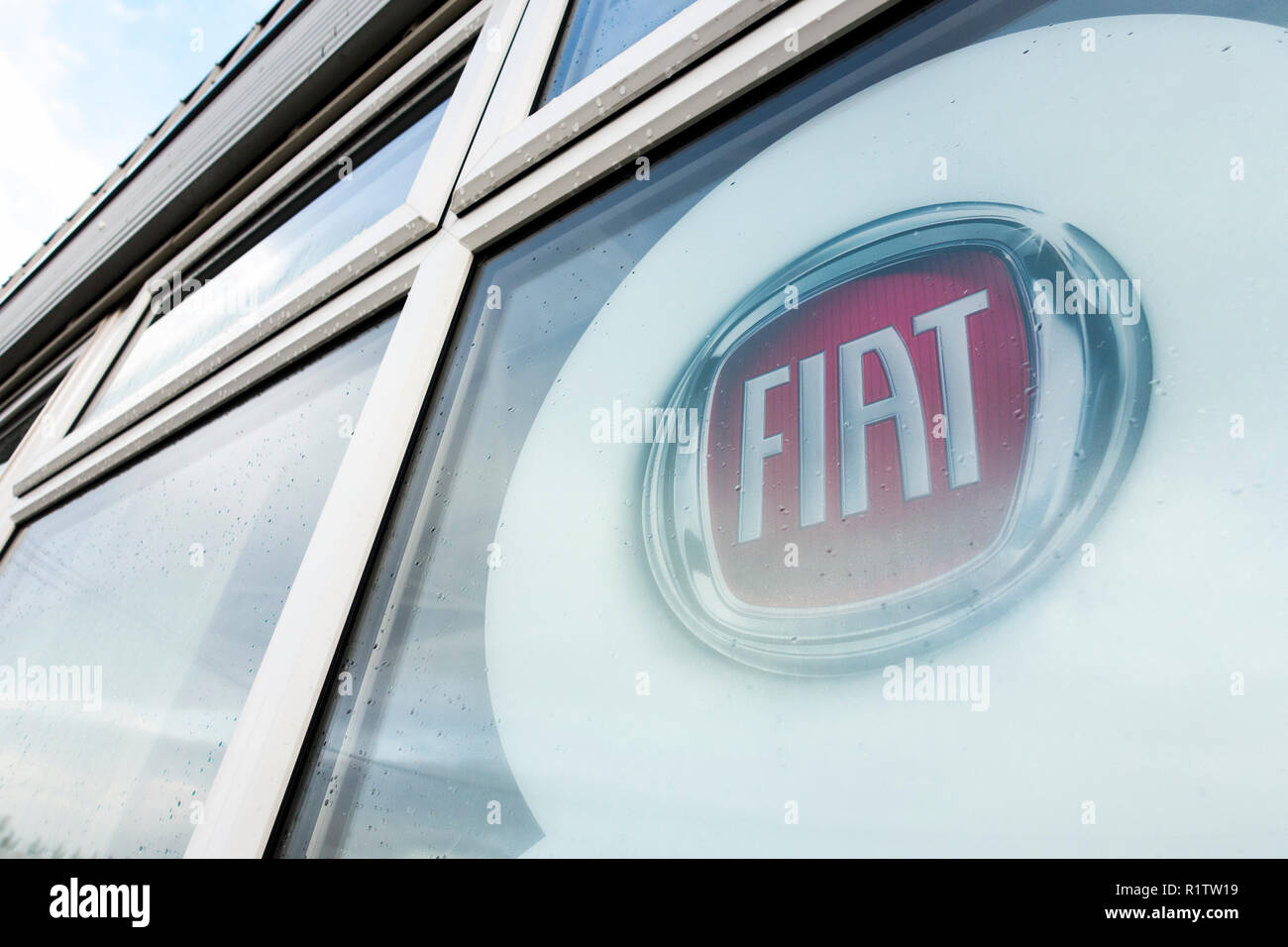 Stickers on the windows of a closed and abandoned FIAT car dealership