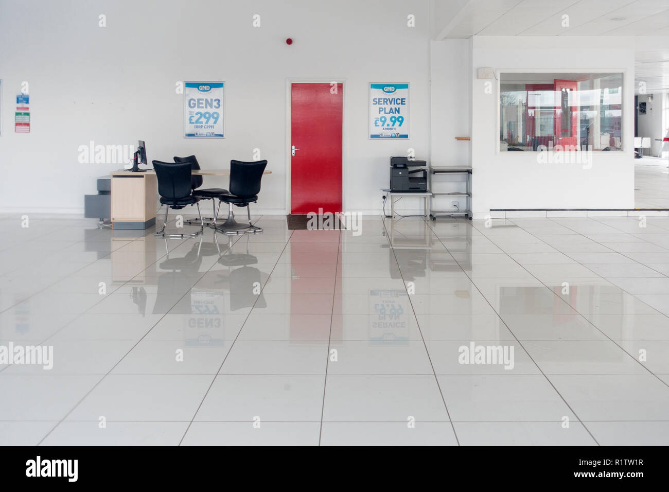 The white tiled showroom of a closed and abandoned FIAT car dealership at Old Pit Lane, Pity Me, Durham, County Durham UK Stock Photo