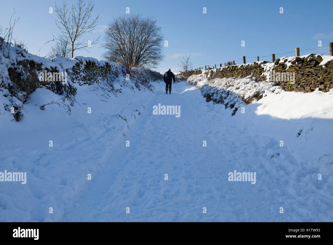 Winter view of a historic walled lane near Meltham in West Yorkshire after snow Stock Photo