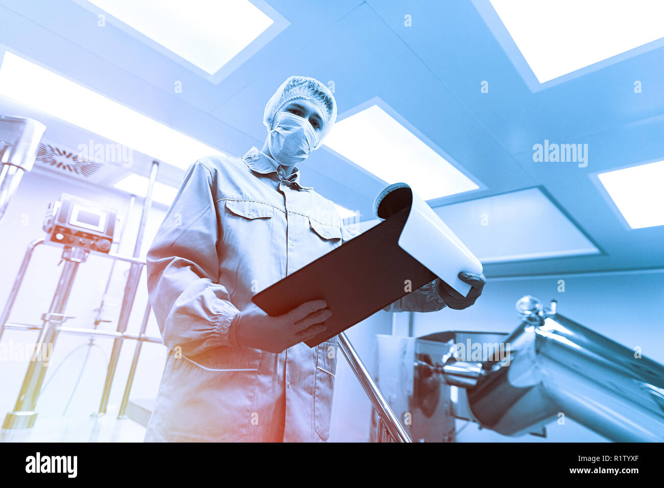 plant picture, scientist is standing on ladder in laboratory. Blue tone. Blue tint Stock Photo