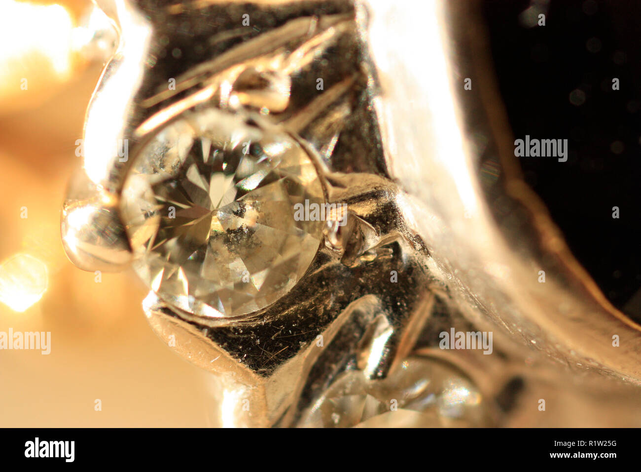 Close up of small diamond in a platinum setting of Sapphire and Diamond Ring Stock Photo