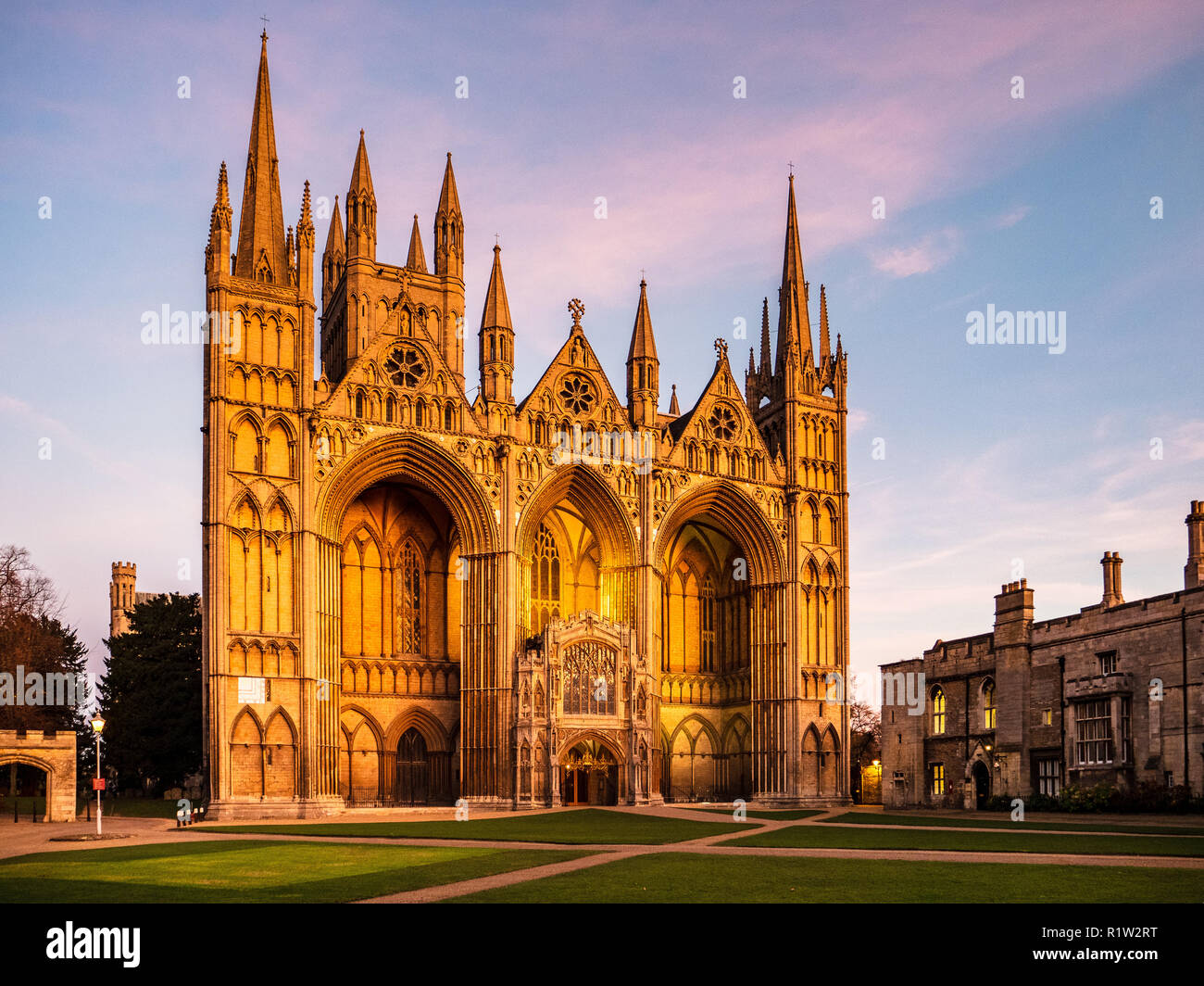 Peterborough Cathedral at dusk aka Cathedral Church of St Peter, St Paul and St Andrew in Peterborough UK.  Romanesque Gothic style built 1118–1237 Stock Photo