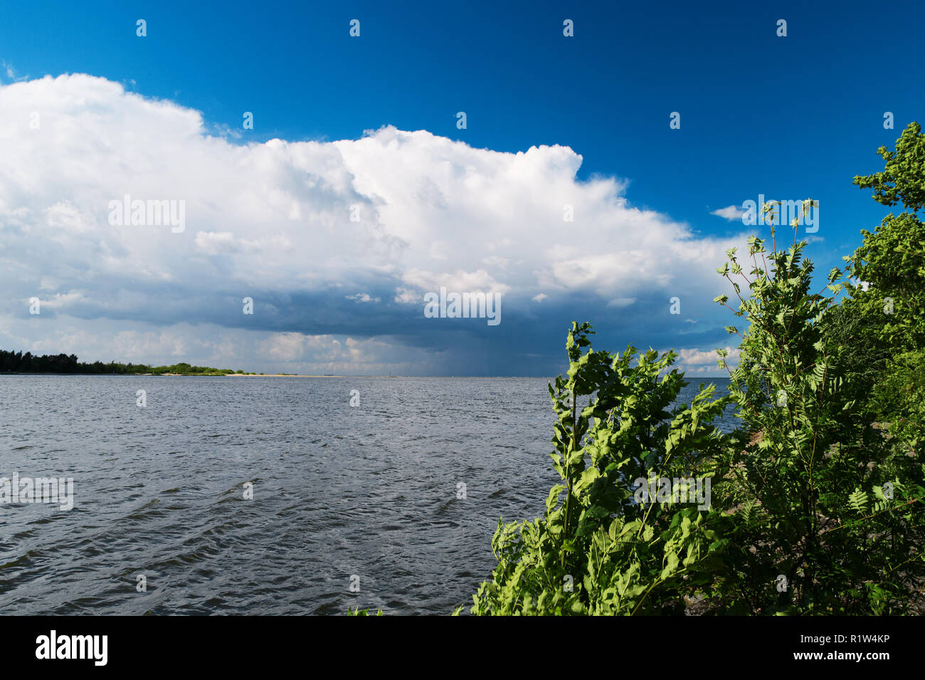 Estuary of the Vistula River to the Baltic Sea with the Cumulus mediocris cloud in the sky. Pomerania, Poland. Stock Photo