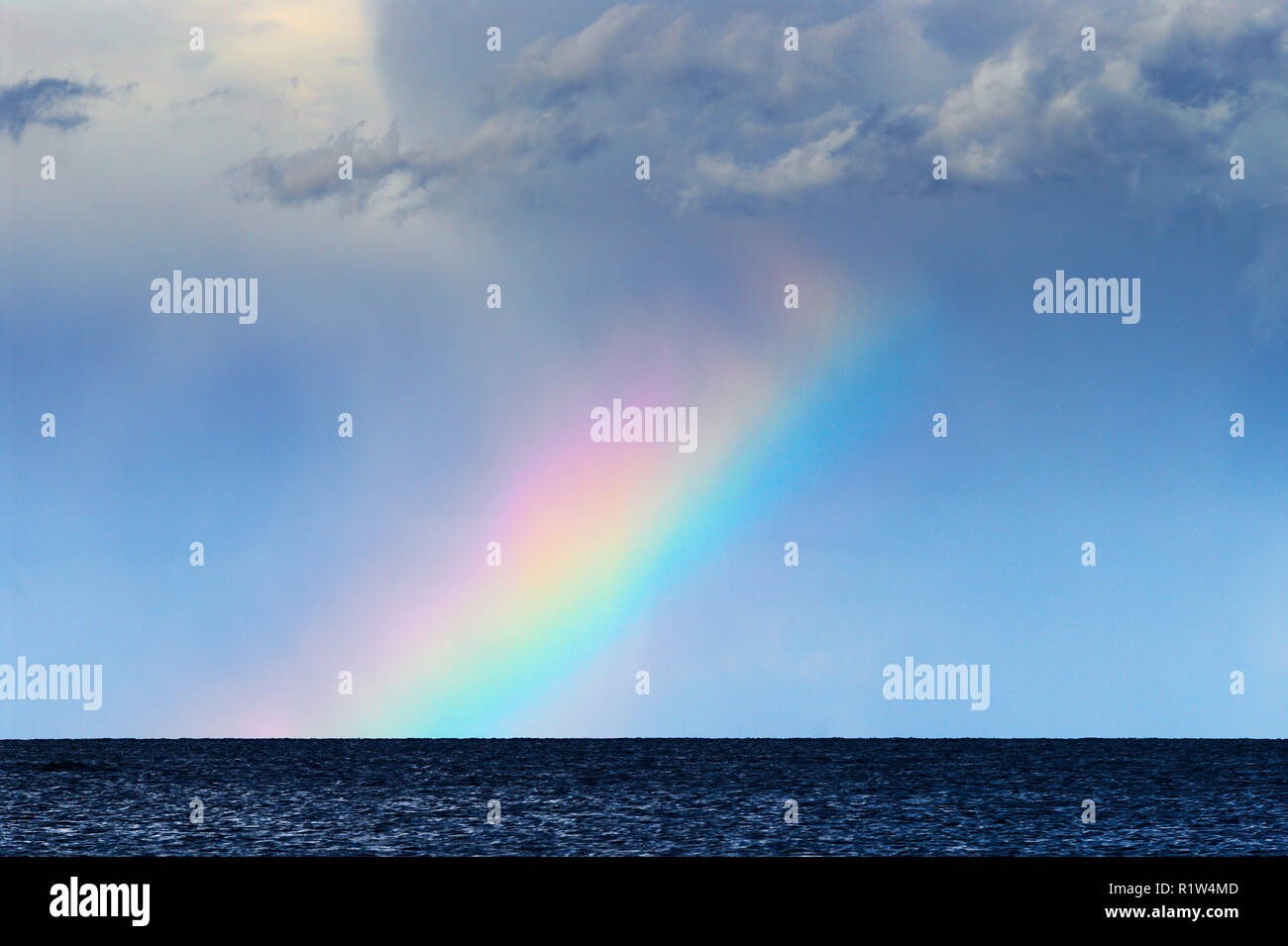 Landscape with colorful rainbow over the Baltic sea horizon. Pomerania, Poland. Stock Photo