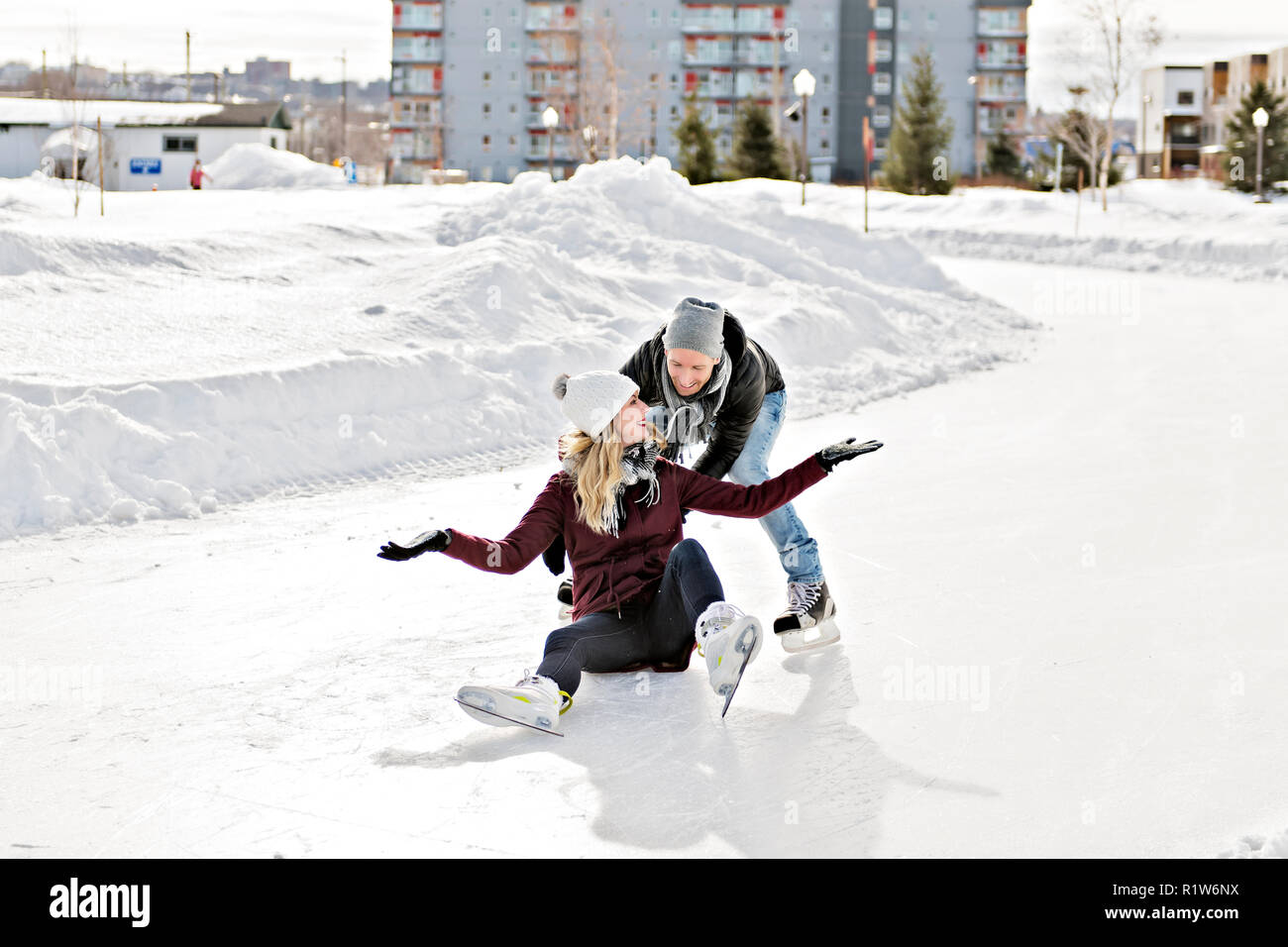 A couple in sunny winter nature ice skating Stock Photo