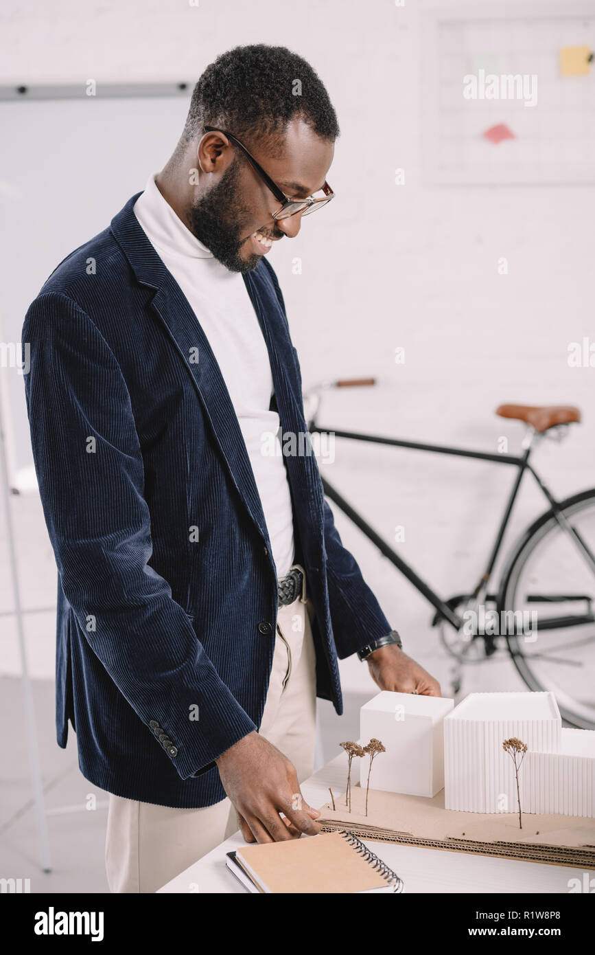 professional cheerful african american architect working with business buildings model in office Stock Photo