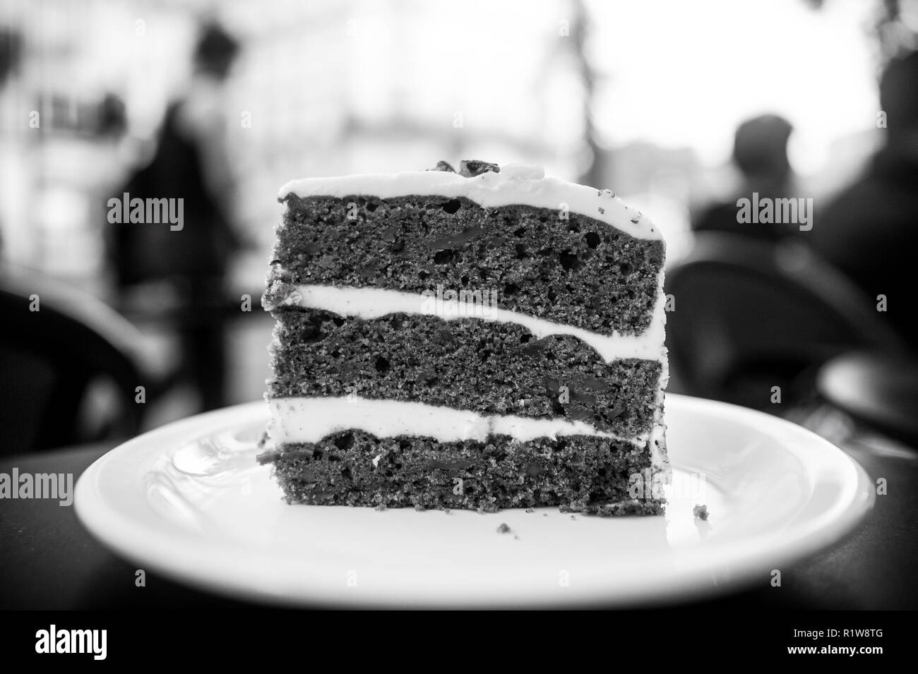 Cake slice on white plate in paris, france, dessert. Cake with cream