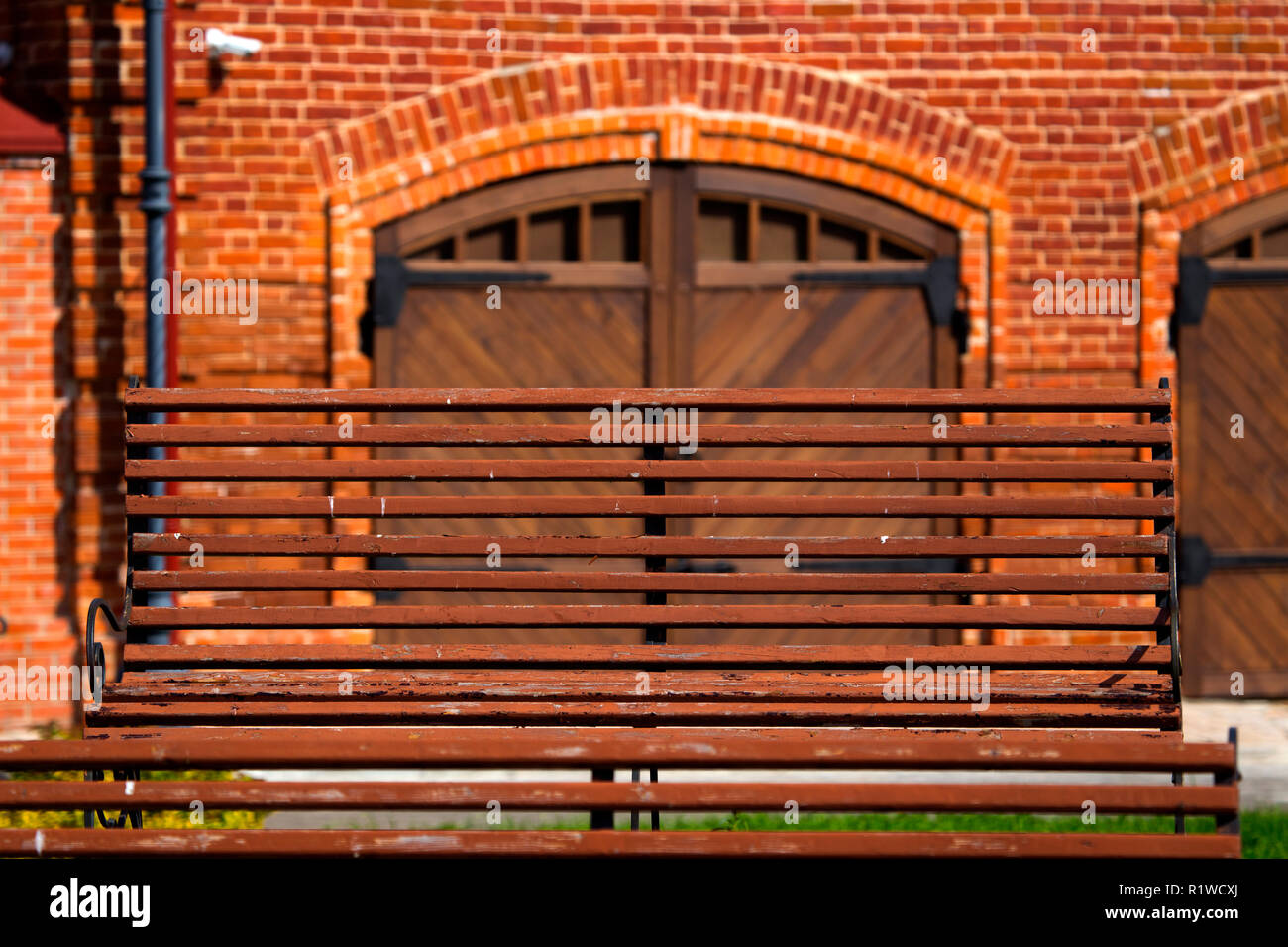 Wooden bench of brick-red color Stock Photo - Alamy