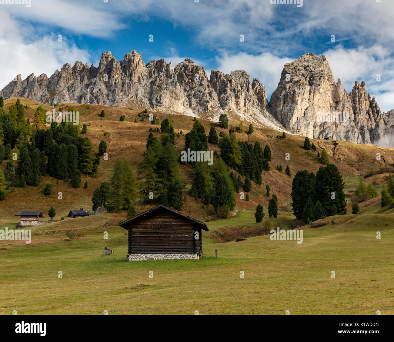 Landscape photo with alpine hut in front of mountain range, Grödnerjoch, Dolomites, South Tyrol, Italy Stock Photo