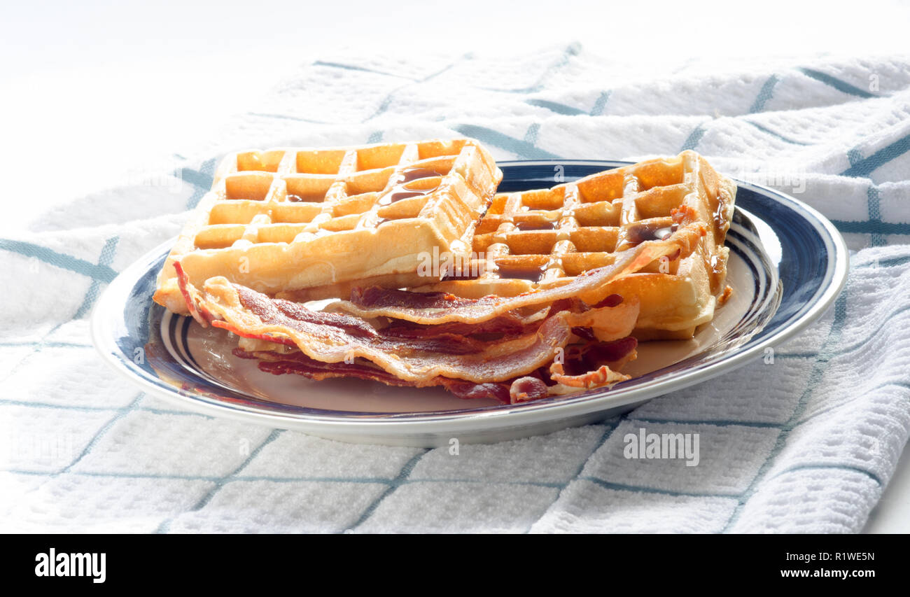 Plate of waffles, maple syrup and bacon Stock Photo
