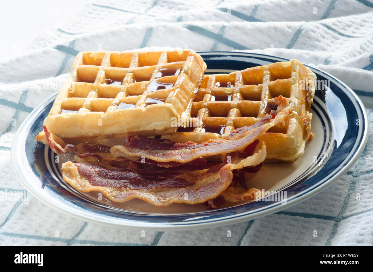 Plate of waffles, maple syrup and bacon Stock Photo