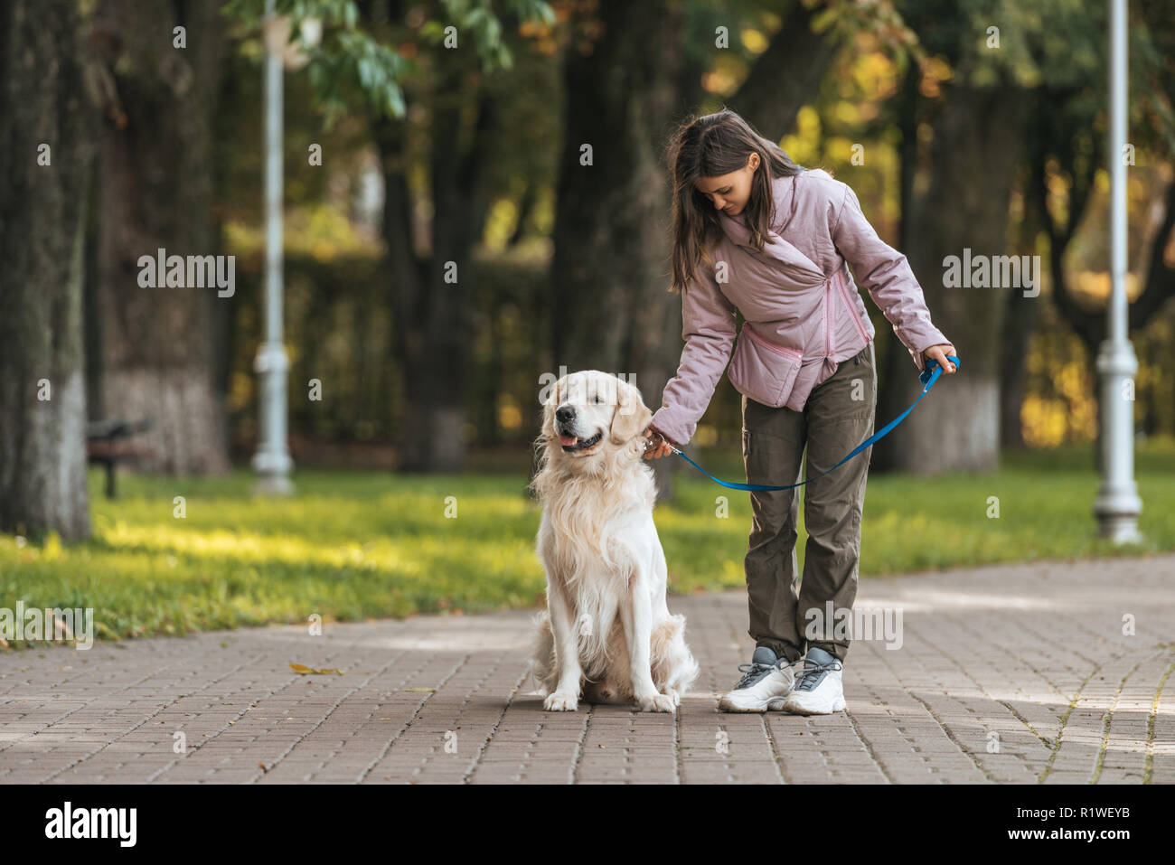 Girl holding dog leash hires stock photography and images Alamy