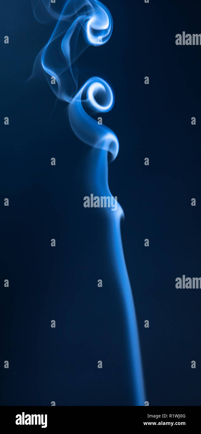 Abstract blue smoke swirls on dark background Stock Photo - Alamy