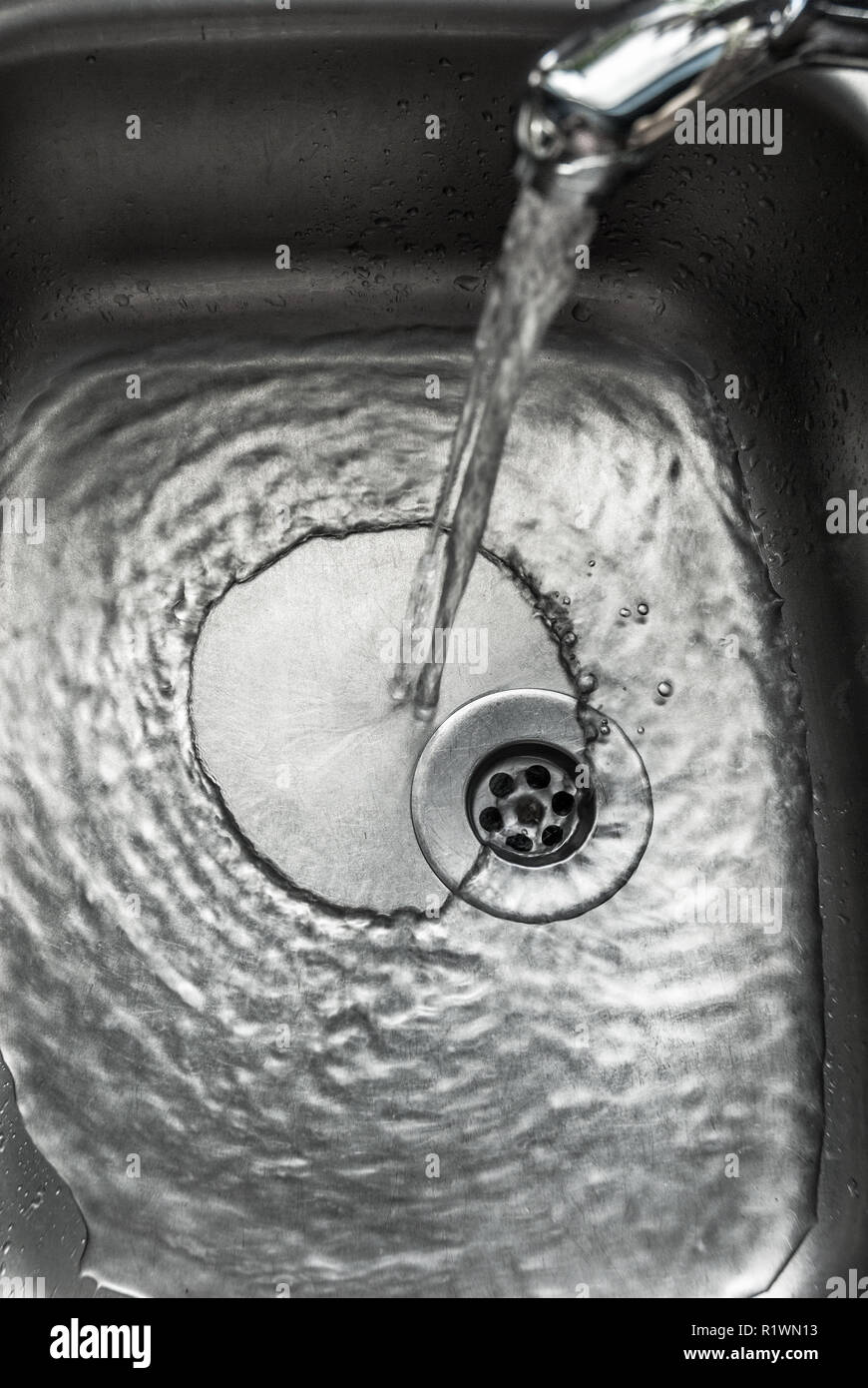 Chrome kitchen sink with pouring water Stock Photo Alamy