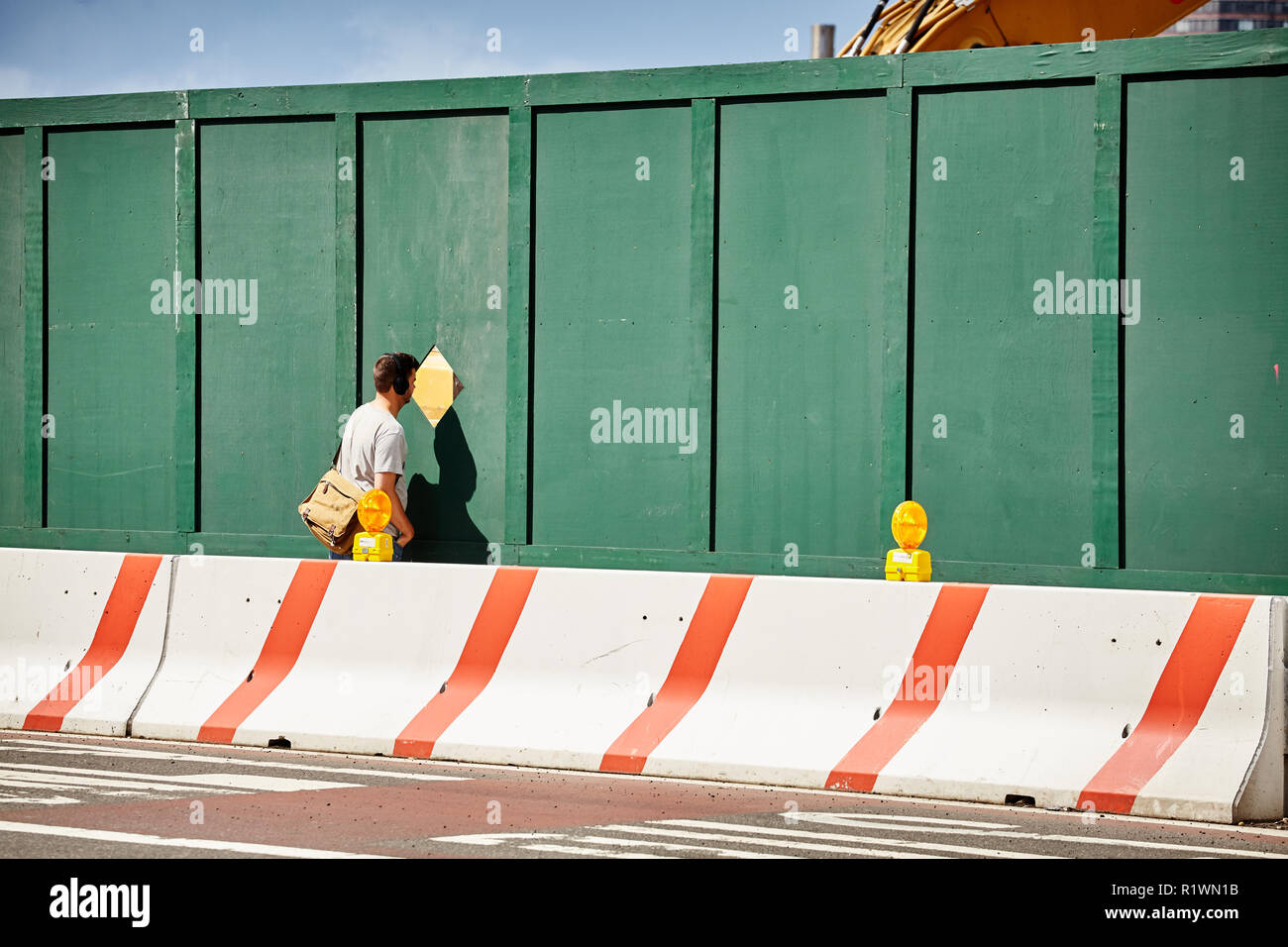 New York, USA June 28, 2018 Man looks through a provisional fence