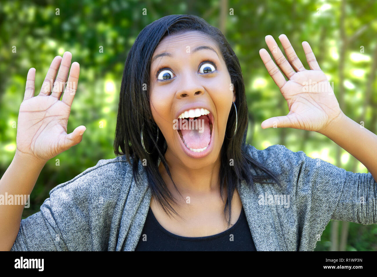 young woman alone in the woods screaming Stock Photo