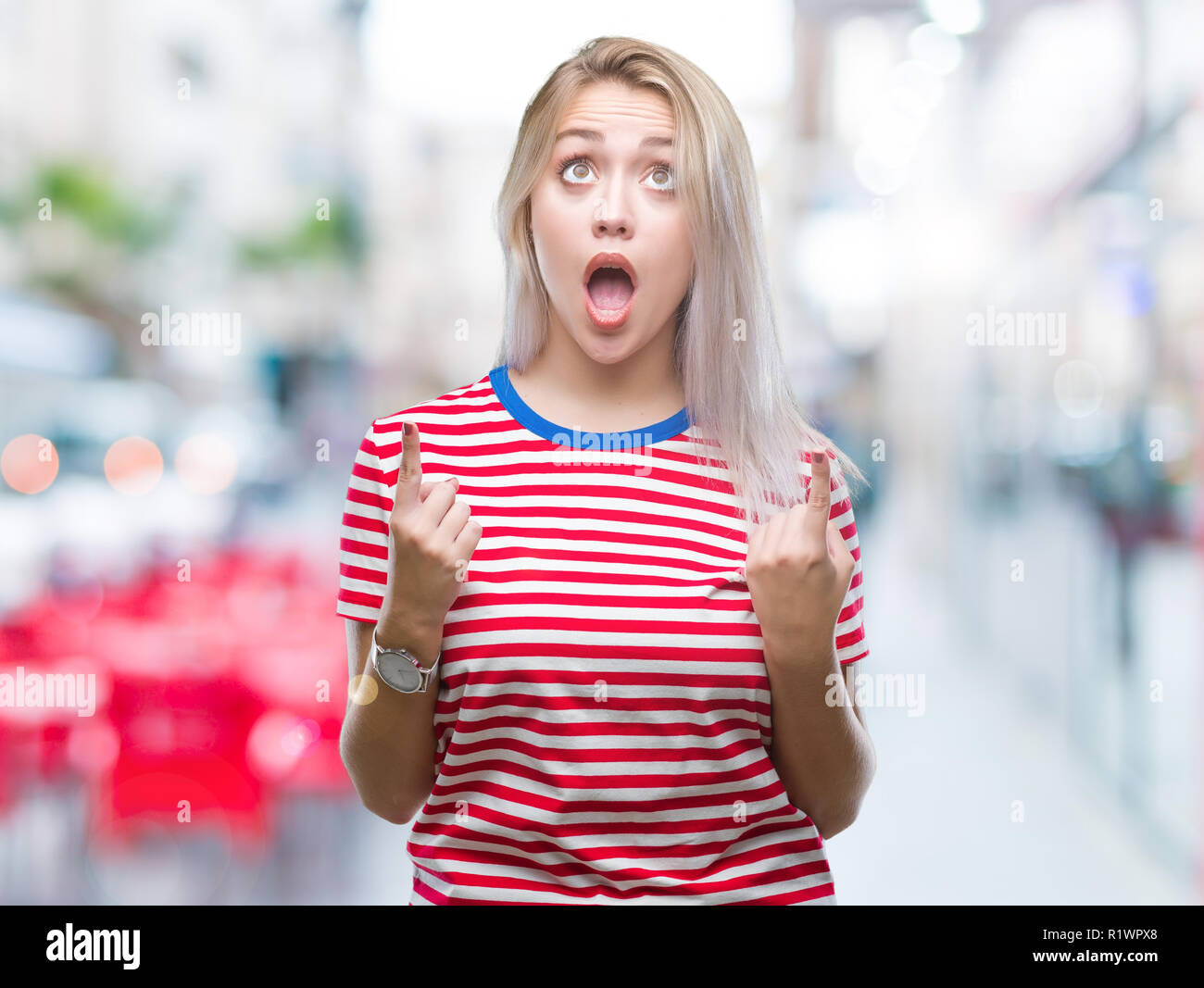 Young blonde woman over isolated background amazed and surprised ...