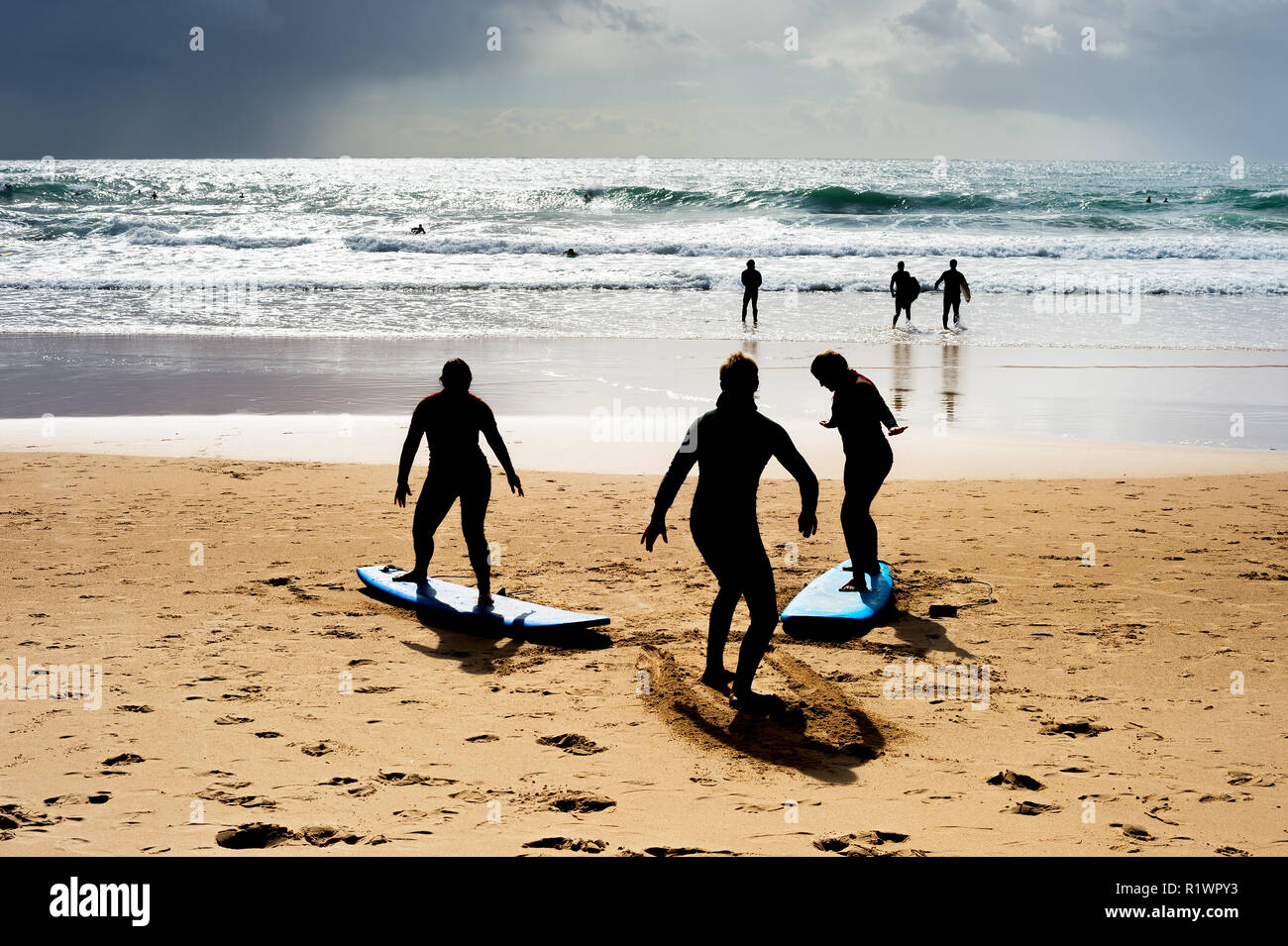 Surfing school learning how to surf at the beach. Portugal Stock Photo