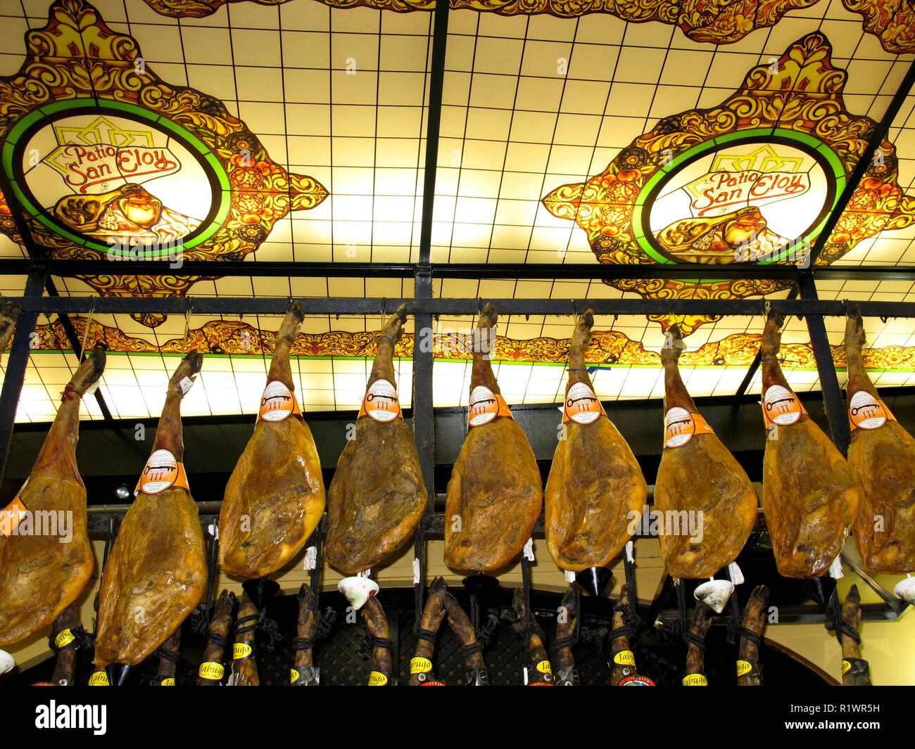 Cured spanish ham hanging at tapas bar. Sevilla. Andalusia. Spain Stock ...