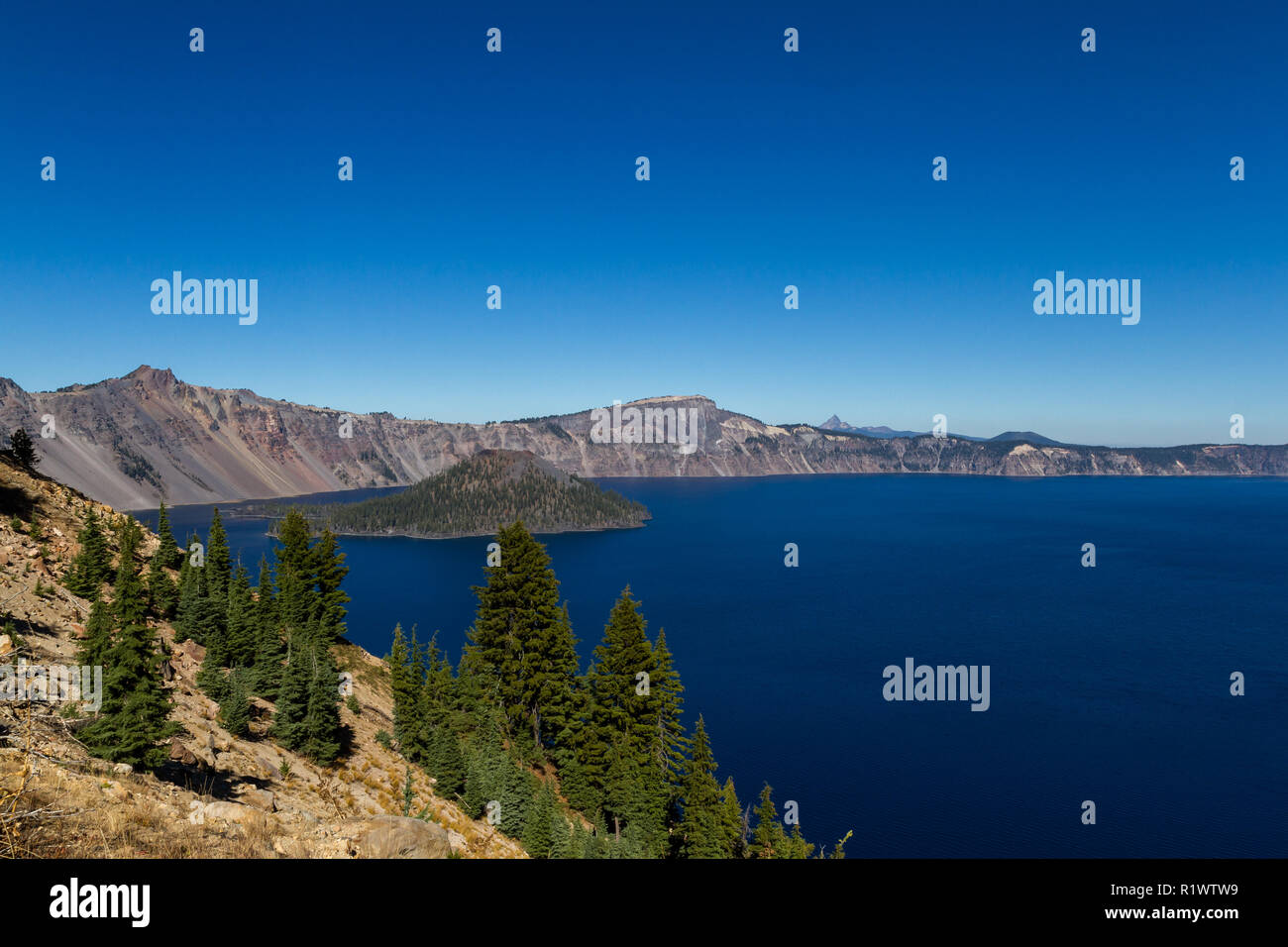 Beautiful day at Crater Lake National Park with a beautiful clear day and a deep blue color in the sky and lake Stock Photo