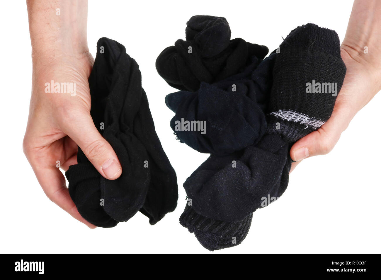 From a pile of dirty black socks a man always chooses the most torn and  smelly concept. Isolated on white studio shot Stock Photo - Alamy