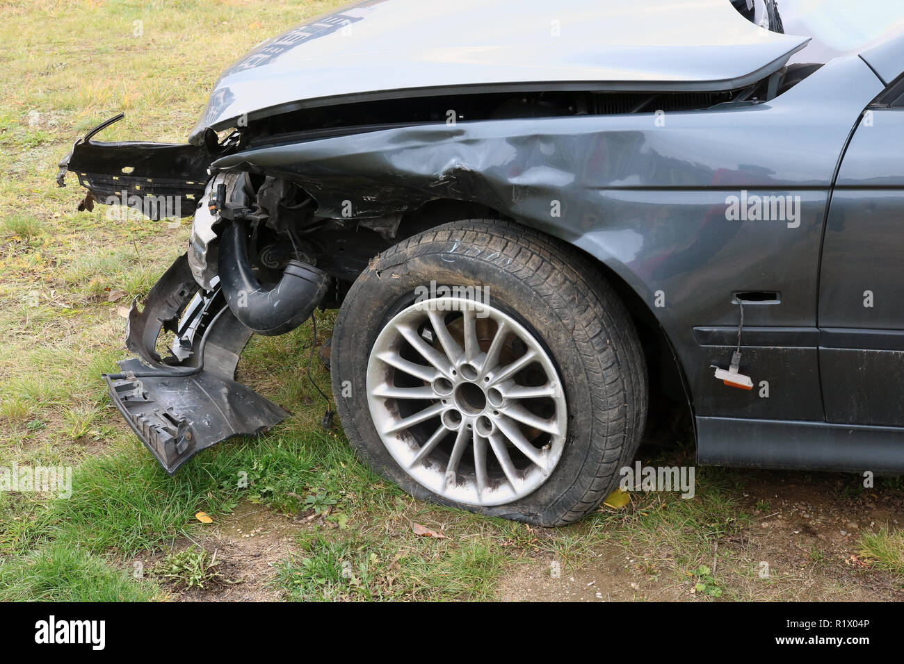 The front part of a crashed broken dirty forgotten no name black passenger car Stock Photo