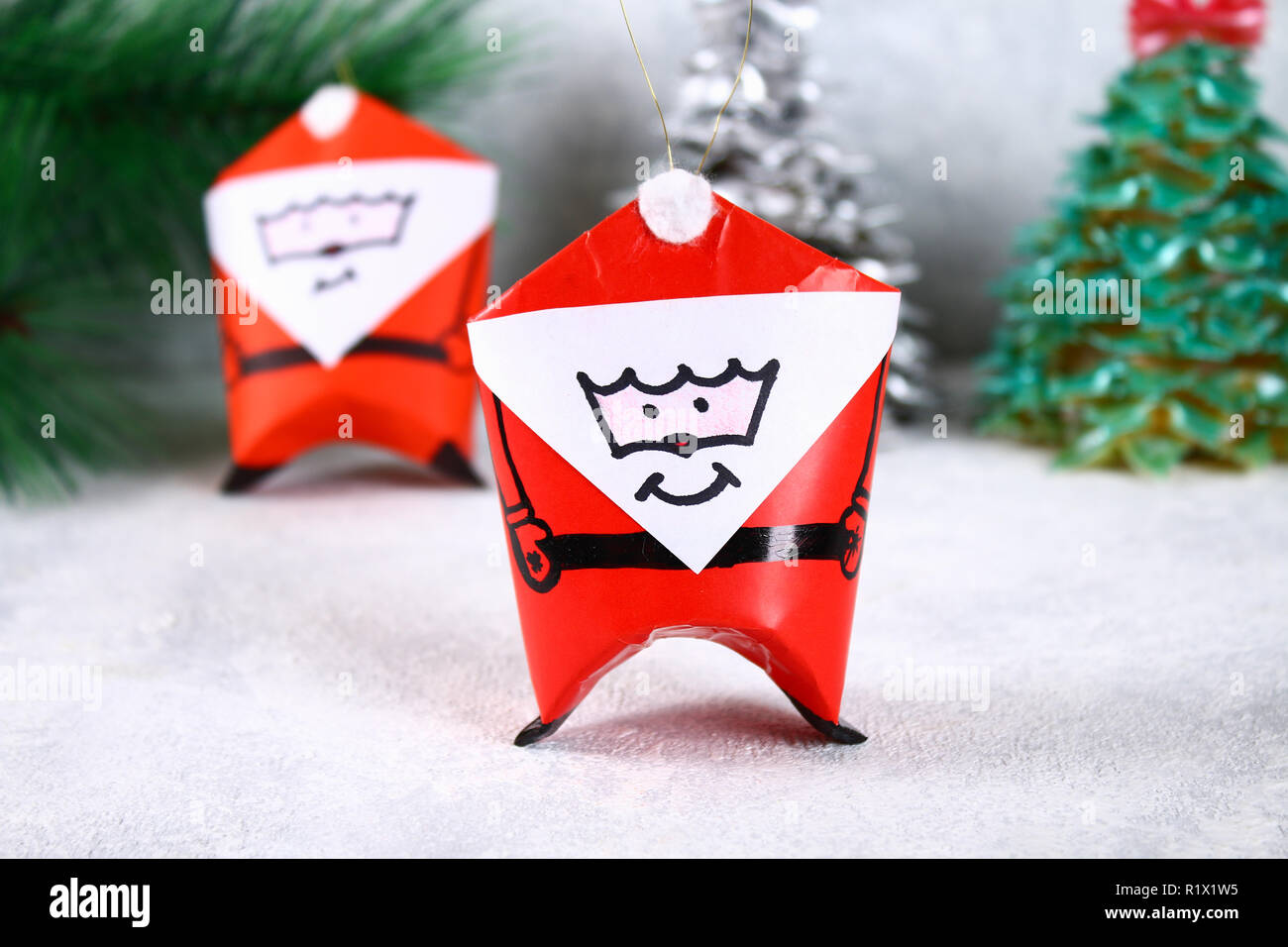 Christmas Santa Claus made from toilet paper hub, colored paper, marker,  glue, fishing line and cotton pad. DIY toy on the Christmas tree. Handmade  Gu Stock Photo - Alamy