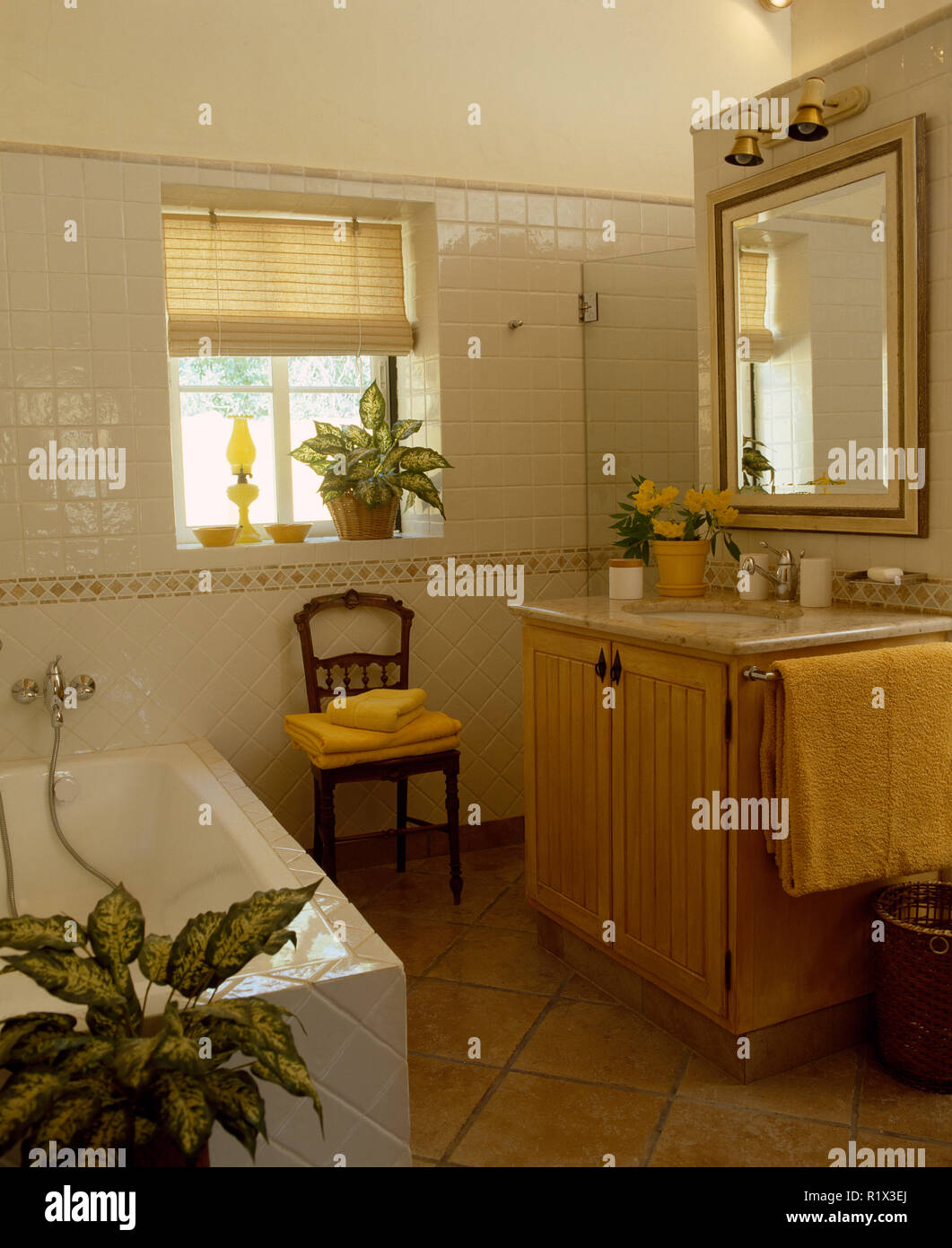 Mirror above basin in vanity unit in Portuguese bathroom Stock Photo