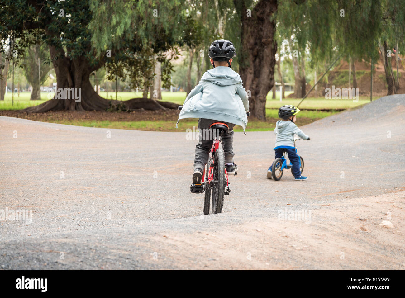 Two australian kids riding their bicycles on special bike track in Adelaide, South Australia Stock Photo