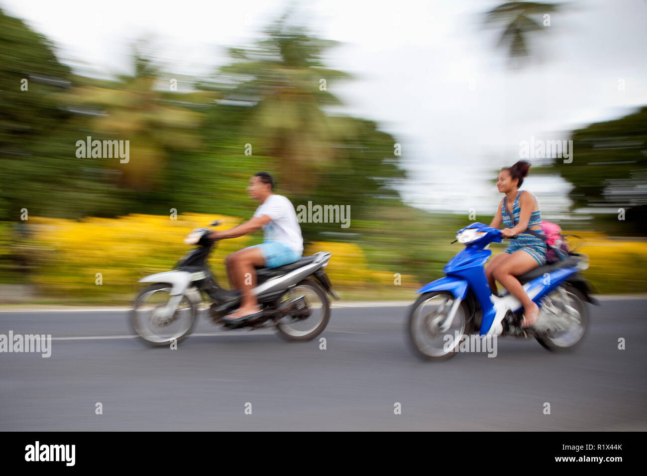 Mopeds on the move on Rarotonga, Cook Islands. Stock Photo
