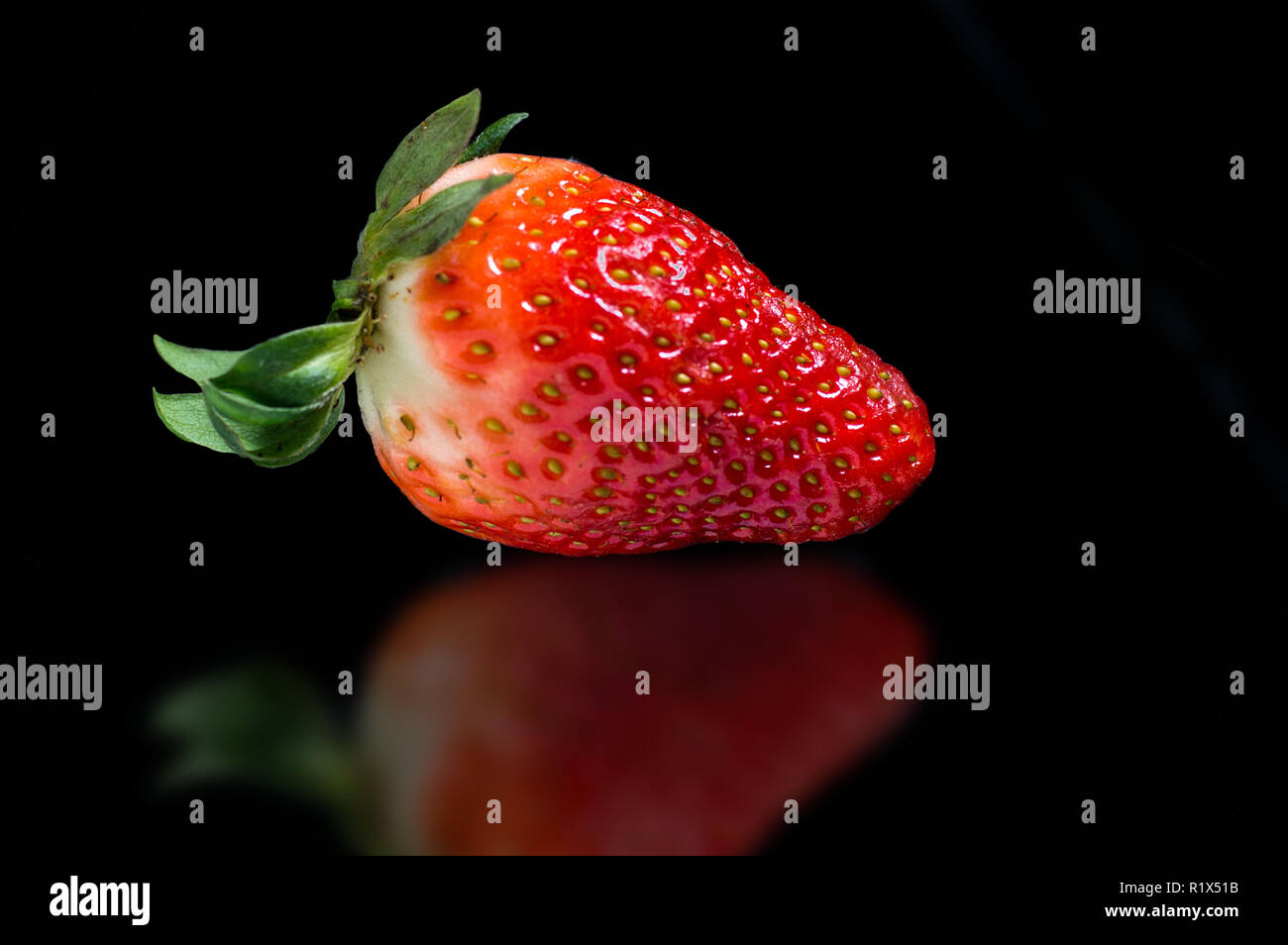 Strawberry on a black background Stock Photo - Alamy