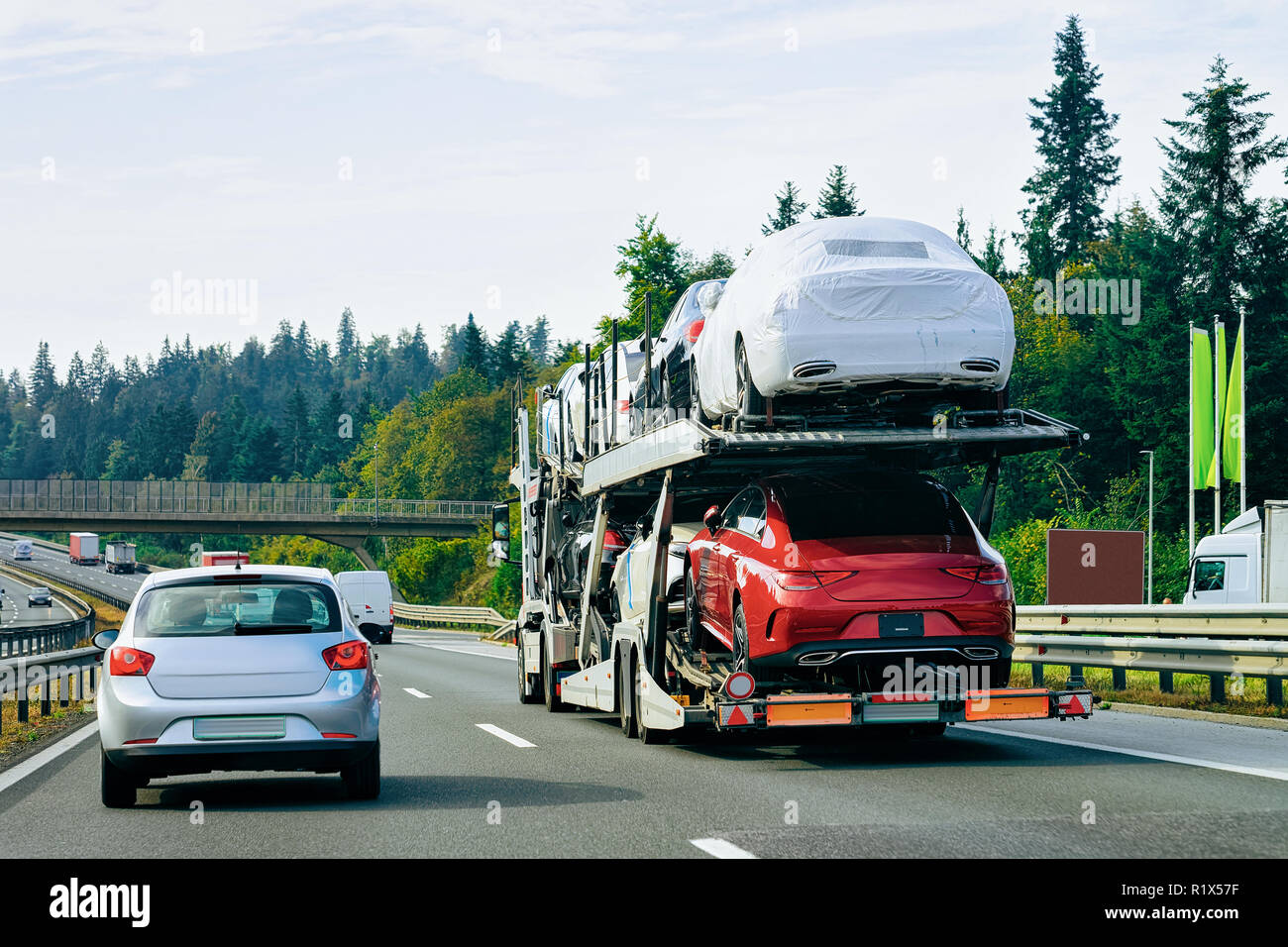 Cars carrier truck at the asphalt road in Slovenia. Truck transporter ...