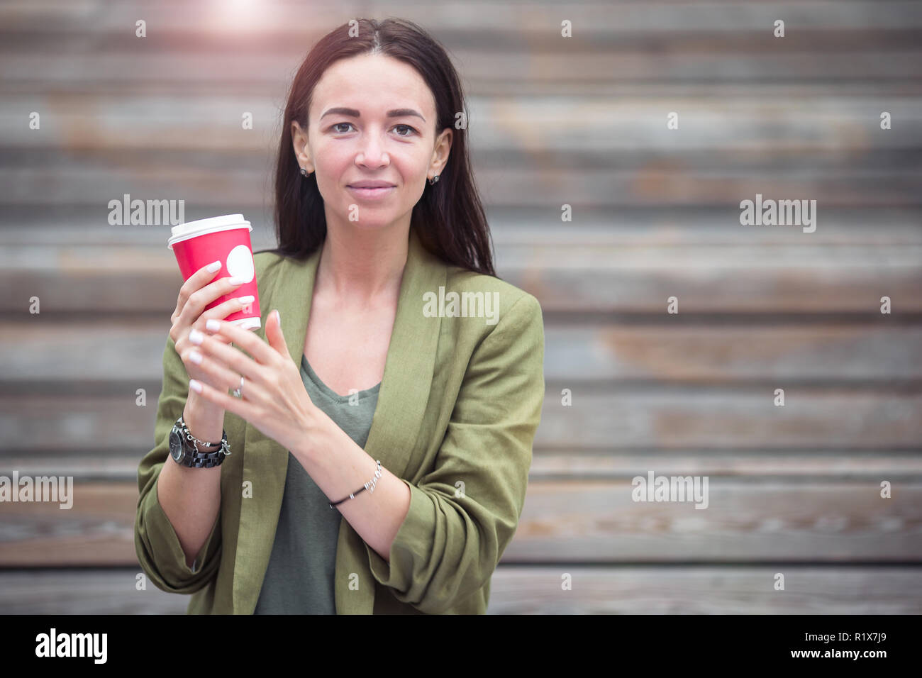 Woman drinking tasty coffee outdoors in the park Stock Photo