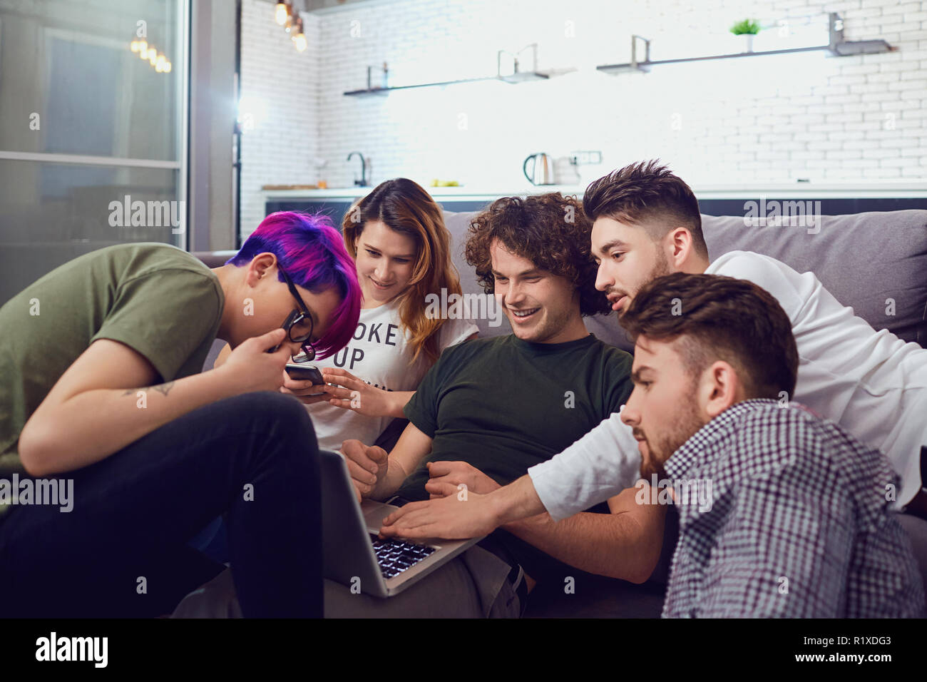 A group of friends of students in leisure with a laptop together Stock Photo