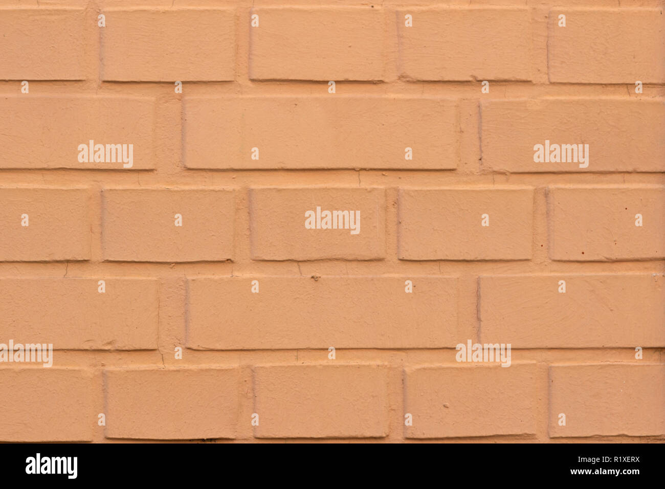 Painted orange brick wall texture background Stock Photo