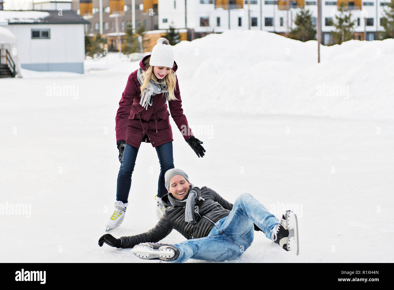 A couple in sunny winter nature ice skating Stock Photo