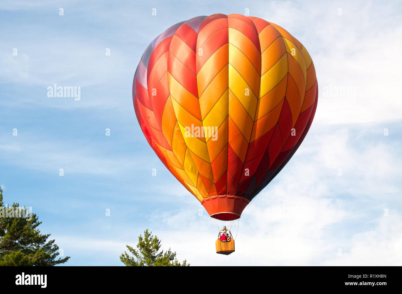 The balance of the air and wind helps float this hot air balloon. Stock Photo