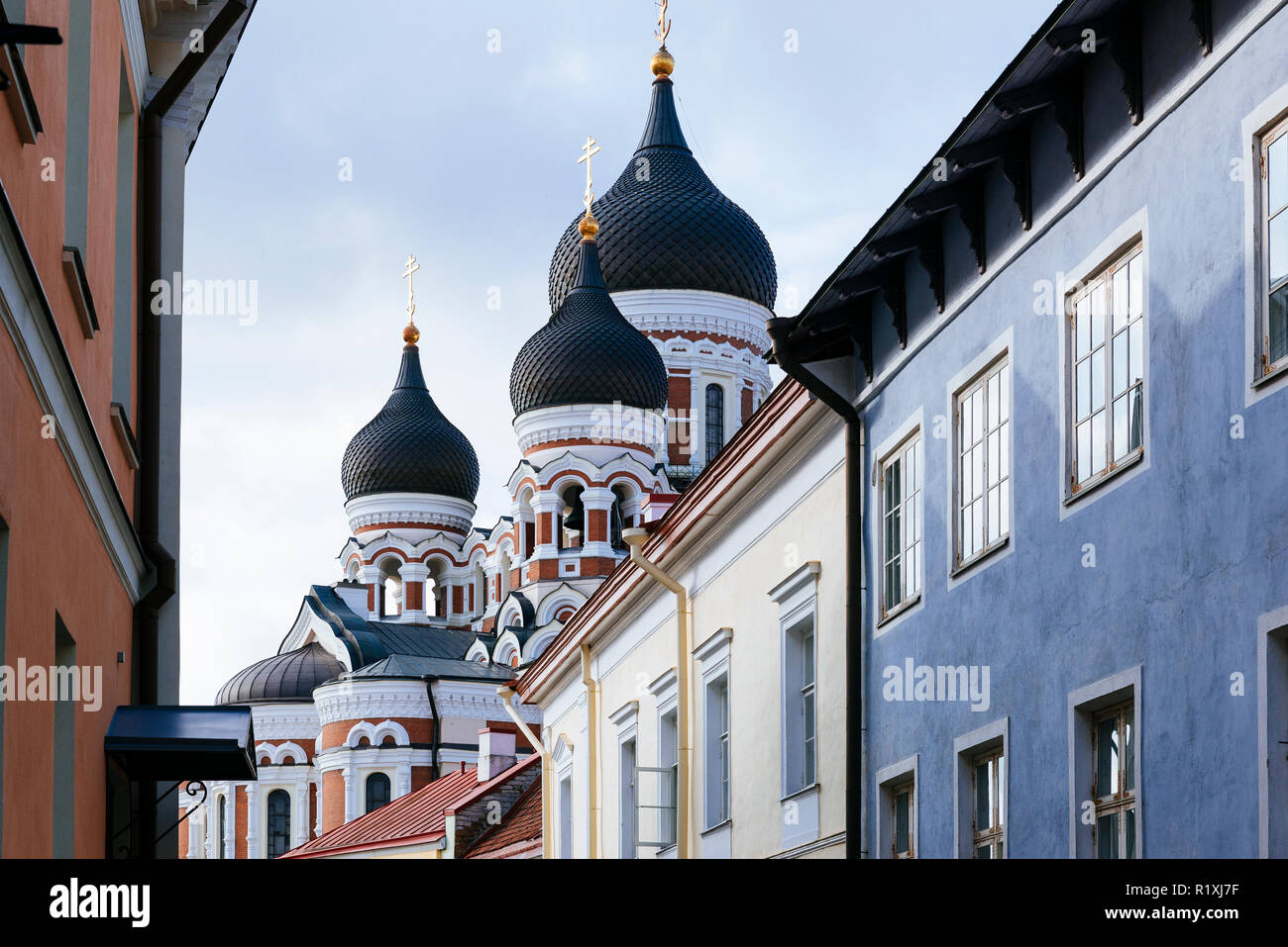 The onion domes of Alexander Nevsky Cathedral peek through the rooftops. Tallinn, Harju County, Estonia, Baltic states, Europe. Stock Photo