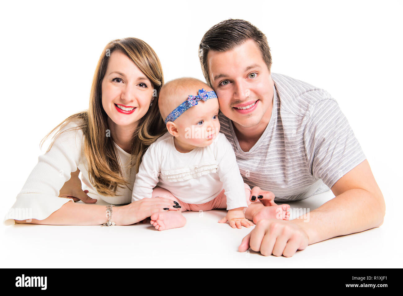 A Young father, mother cute baby girl over white background Stock Photo