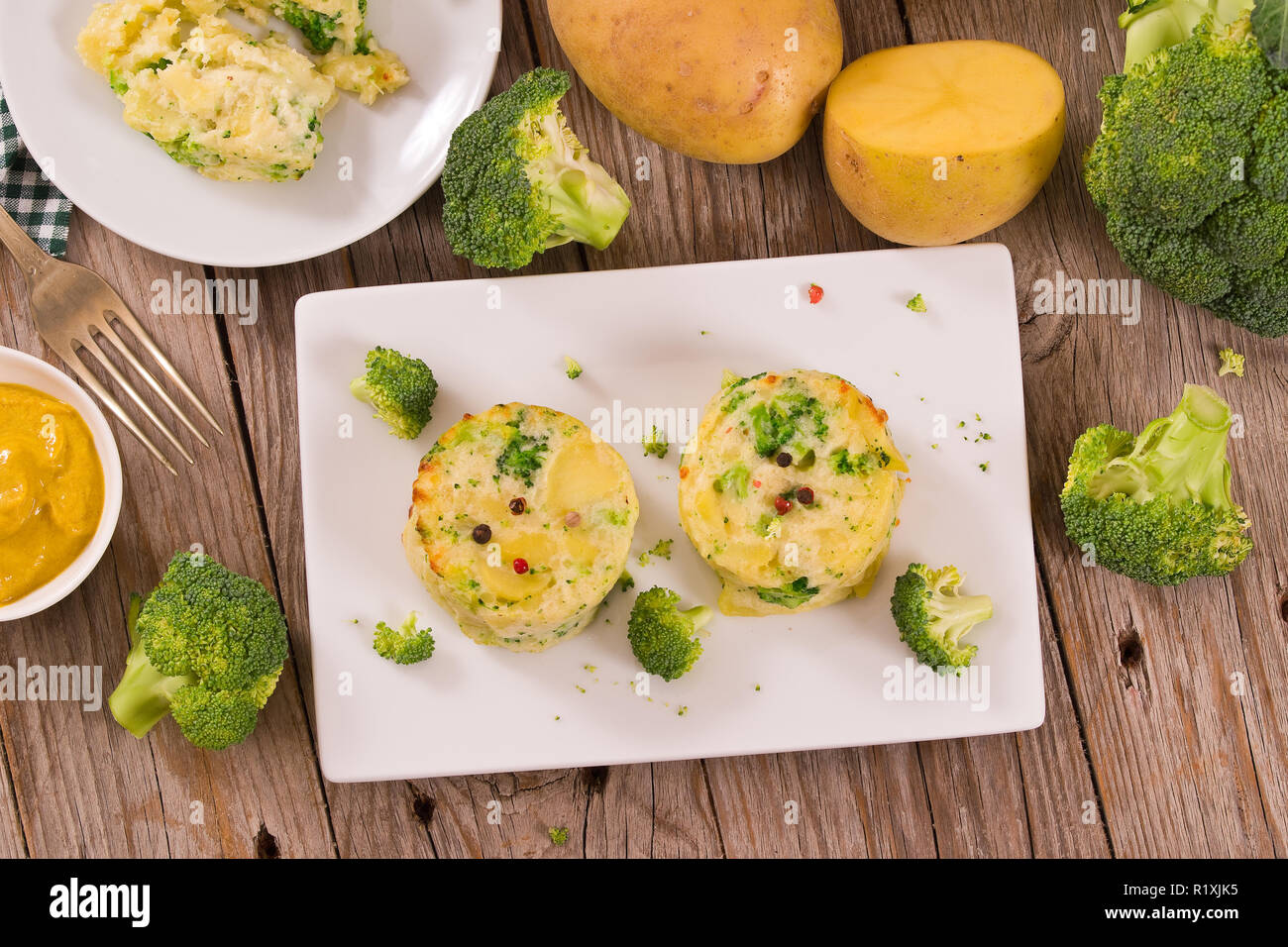 Potato gratins with broccoli florets Stock Photo Alamy
