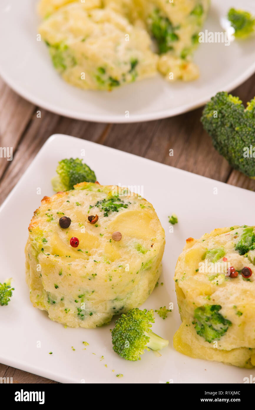 Potato gratins with broccoli florets Stock Photo Alamy