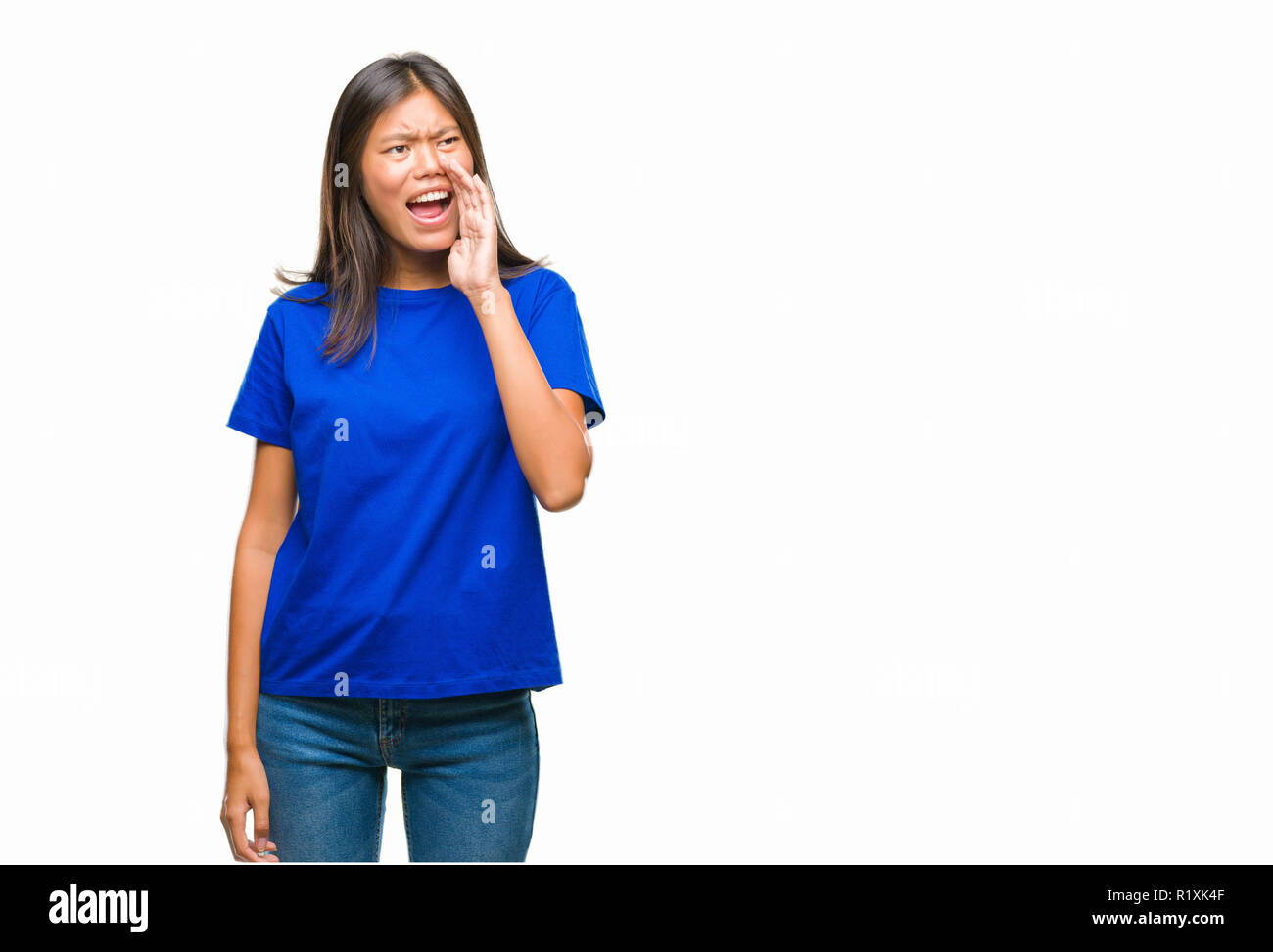 Young asian woman over isolated background shouting and screaming loud ...