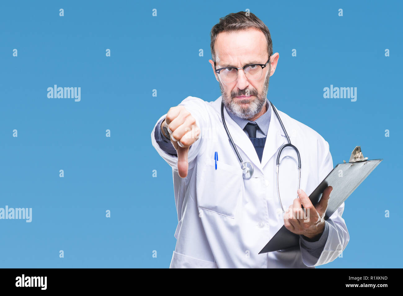 Middle age senior hoary doctor man holding clipboard over isolated ...