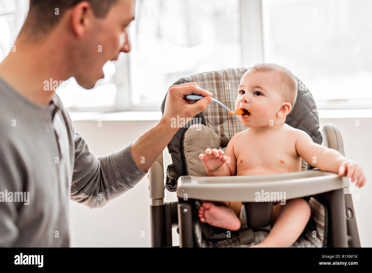 A Father and baby eat with the spoon feed Stock Photo