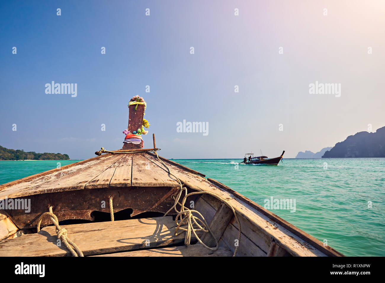 Cruise at long tail boat with view to tropical islands at sunset in Andaman Sea, Thailand Stock Photo