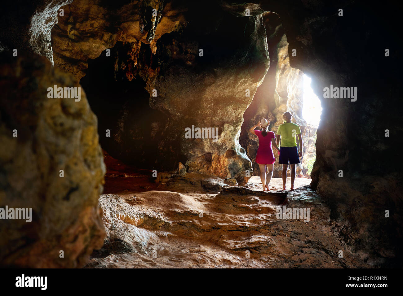 Happy young couple in the big cave at Phra Nang beach, Krabi province in Southern Thailand. Travel magazine concept. Stock Photo